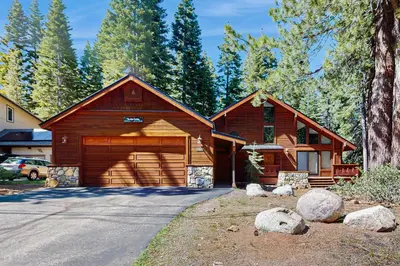 a large wooden house with a garage at Seclusion in Style in Truckee
