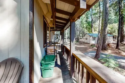 a porch of a house with a trash can at Snowpeak Chalet in Camp Connell
