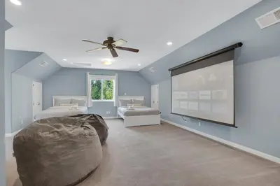 a bedroom with a large screen in the middle of it at Moonrise Lodge - A Large Vacation Home in Mariposa in Mariposa