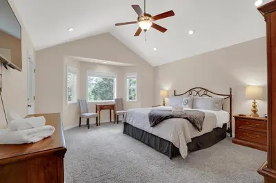 a bedroom with a bed and a ceiling fan at Moonrise Lodge - A Large Vacation Home in Mariposa in Mariposa