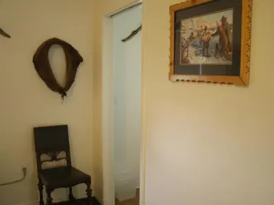 a hallway with a chair and a picture on the wall at Virginia City Inn in Virginia City
