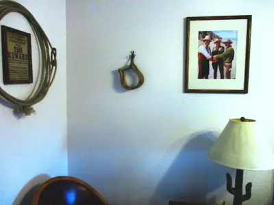 a room with a picture on the wall and a lamp at Virginia City Inn in Virginia City
