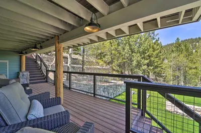 a porch with a couch and chairs on a balcony at Hot Tub, Pool Table Luxe Reno Chalet with Mtn View! in Reno
