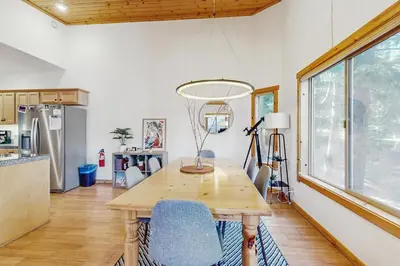 a dining room with a wooden table and chairs at Truckee Treat in Truckee