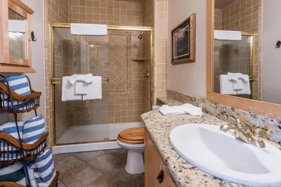 a bathroom with a sink and a toilet and a shower at Juniper Springs Lodge #413 - Luxury Ski in Ski out! 2 Bedroom in Mammoth Lakes