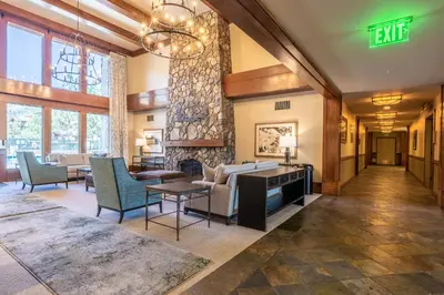 a lobby with a living room with furniture and a fireplace at Juniper Springs Lodge #413 - Luxury Ski in Ski out! 2 Bedroom in Mammoth Lakes