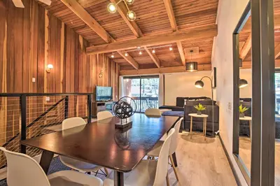 a dining room and living room with a table and chairs at Contemporary Mountain Retreat - Walk to Slopes! in Mammoth Lakes