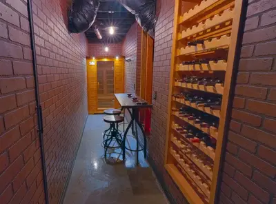 a wine cellar with a stool in a brick wall at Cozy mountain retreat with lake views near Yosemite in Groveland