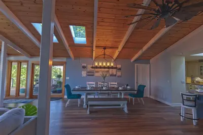 a dining room with a table and chairs and a ceiling at Cozy mountain retreat with lake views near Yosemite in Groveland