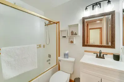 a bathroom with a toilet and a sink and a mirror at 1 Mi to Northstar Skiing Cozy Pet-Friendly Condo! in Truckee