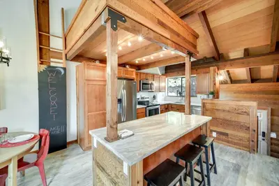 a kitchen with wooden walls and a counter with chairs at 1 Mi to Northstar Skiing Cozy Pet-Friendly Condo! in Truckee