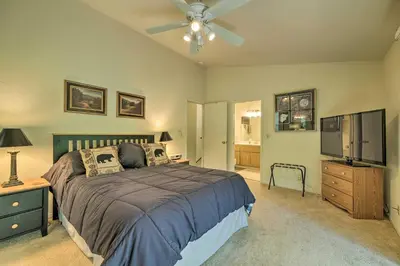 a bedroom with a bed and a flat screen tv at Pine Mountain Lake Haven with Spacious Deck! in Groveland