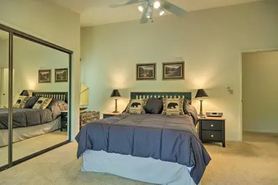 a bedroom with two beds and a large mirror at Pine Mountain Lake Haven with Spacious Deck! in Groveland