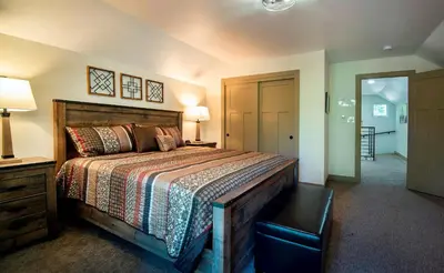 a bedroom with a large bed with a wooden headboard at 12R Hilltop Haven in North Wawona
