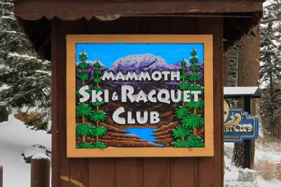a sign for a ski resort club in the snow at Mammoth Ski Racquet Club 105 - Pet Friendly in Mammoth Lakes