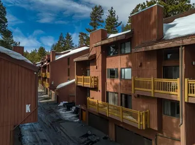a row of apartment buildings with yellow balconies at Mammoth Ski Racquet Club 105 - Pet Friendly in Mammoth Lakes