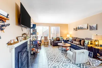 a living room with a couch and a fireplace at 11529 Snowpeak Way #619 in Truckee