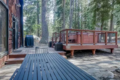 a wooden deck with a bench on the side of a house at Hammock Holidays in Truckee