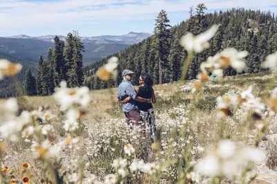 a man and woman standing in a field of flowers at Modern Hotel-Style Studio - Timber Creek Lodge #210 Hotel Room in Truckee