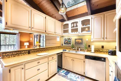 a kitchen with white cabinets and a sink at Beautiful 4-Bedroom Contemporary Mountain Home condo in Truckee