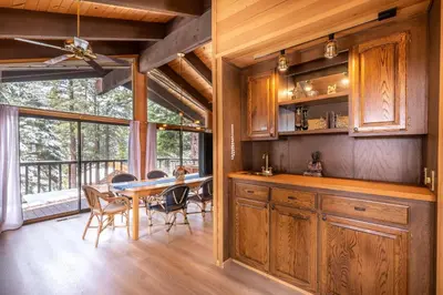 a kitchen with a table and a dining room at Beautiful 4-Bedroom Contemporary Mountain Home condo in Truckee