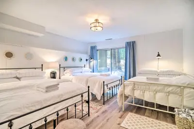 a bedroom with two beds and a window at Pine Mountain Cabin with Hot Tub, 2 Mins to Marina! in Groveland