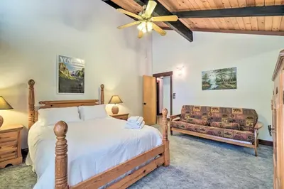a bedroom with a bed and a couch at Cabin Less Than Half-Mi from Pine Mountain Lake Marina! in Groveland