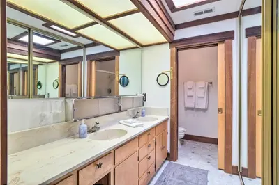 a bathroom with two sinks and a large mirror at Cabin Less Than Half-Mi from Pine Mountain Lake Marina! in Groveland