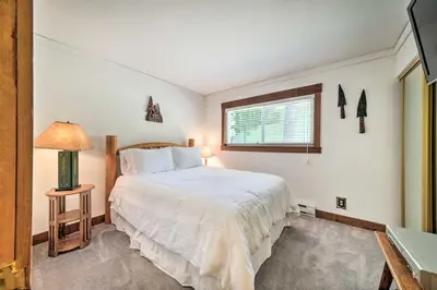 a bedroom with a large white bed and a window at Cabin Less Than Half-Mi from Pine Mountain Lake Marina! in Groveland