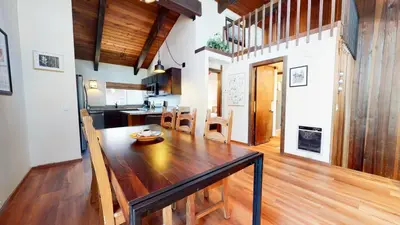 a kitchen and dining room with a wooden table at Mammoth Estates #113 condo in Mammoth Lakes