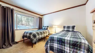 a bedroom with two beds and a window at Mammoth Estates #113 condo in Mammoth Lakes