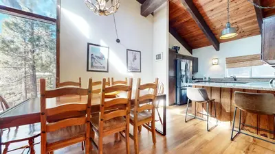 a dining room and kitchen with a table and chairs at Mammoth Estates #113 condo in Mammoth Lakes