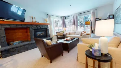 a living room with a couch and a fireplace at Silver Bear #21 condo in Mammoth Lakes