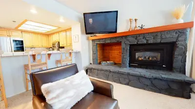 a living room with a fireplace and a television at Silver Bear #21 condo in Mammoth Lakes