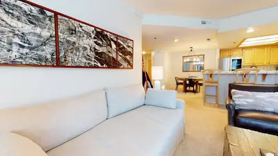 a living room with a couch and a kitchen at Silver Bear #21 condo in Mammoth Lakes