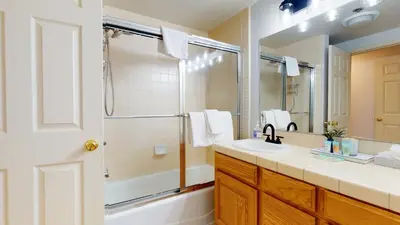 a bathroom with a tub and a sink and a shower at Silver Bear #21 condo in Mammoth Lakes