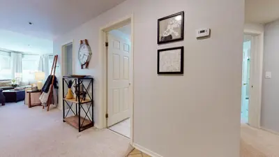a living room with a white wall and a door at Silver Bear #21 condo in Mammoth Lakes