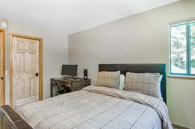 a bedroom with a bed and a desk with a computer at Blue Antler in Truckee