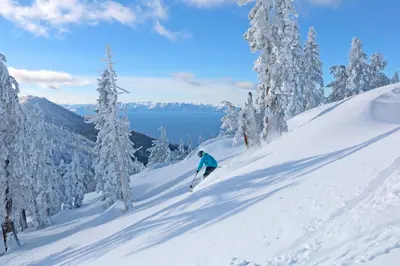 a person is skiing down a snow covered slope at Tahome & Tahoe Place in Incline Village