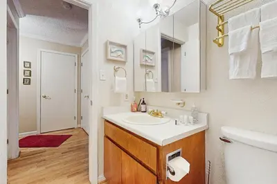 a white bathroom with a sink and a toilet at Tahome & Tahoe Place in Incline Village