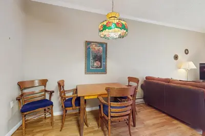 a dining room with a table and chairs and a couch at Tahome & Tahoe Place in Incline Village