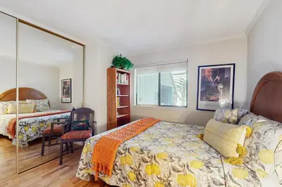 a bedroom with two beds and a mirror at Tahome & Tahoe Place in Incline Village
