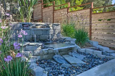 a garden with a water fountain in the middle at Sierra Sunset Inn - 3 Miles to Placerville! in Placerville