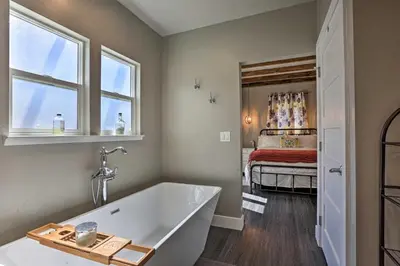 a bathroom with a tub and a bedroom with a bed at Sierra Sunset Inn - 3 Miles to Placerville! in Placerville