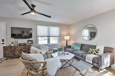 a living room with a couch and a ceiling fan at Hot Tub, Fire Pit Midtown Reno Oasis! in Reno