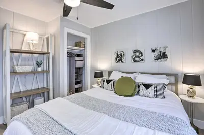 a bedroom with a large white bed with pillows at Hot Tub, Fire Pit Midtown Reno Oasis! in Reno