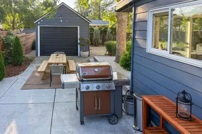 a barbecue grill on a patio next to a house at Hot Tub, Fire Pit Midtown Reno Oasis! in Reno