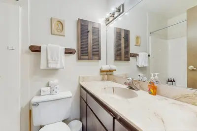 a bathroom with a sink and a toilet and a mirror at Lakeside Dreamzzz in Tahoe Vista