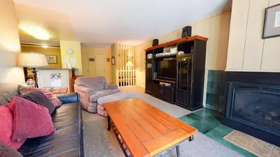 a living room with a couch and a fireplace at Crestview #25 condo in Mammoth Lakes