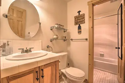 a bathroom with a sink and a toilet and a mirror at Cozy Family Condo in Mammoth Lakes with Balcony in Mammoth Lakes
